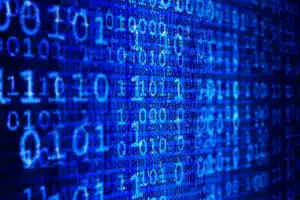 A close-up view of a digital screen filled with glowing blue binary code (zeros and ones), representing data processing and AI learning relating to PHI