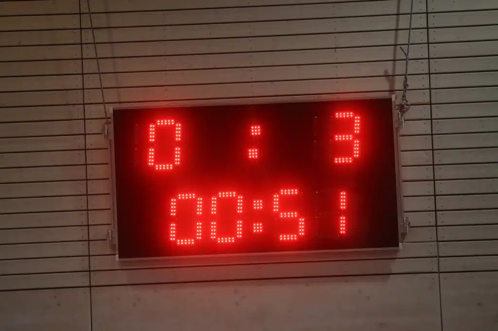 Red digital scoreboard displaying "0:3" and "00:51," used for tracking scores or time in gamified therapy activities.