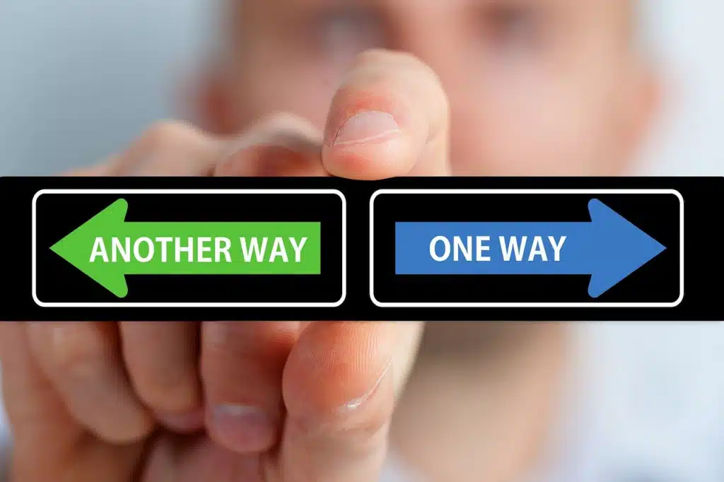 A hand holding two signs, one saying 