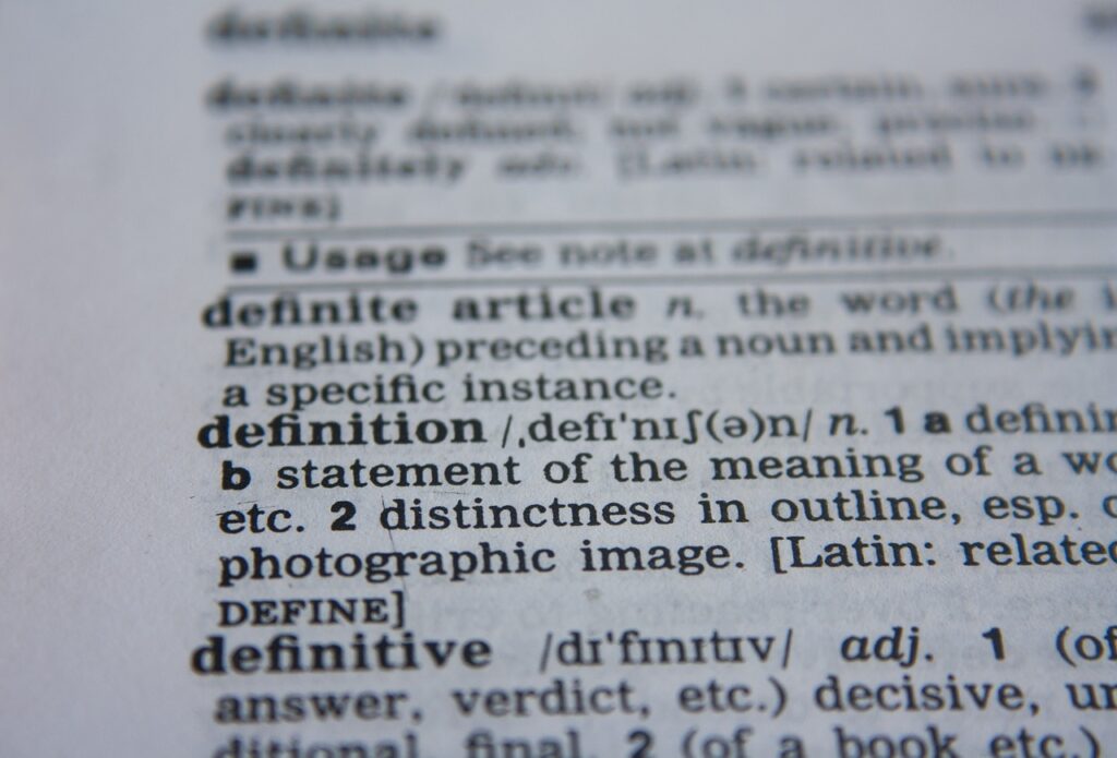 Close-up photograph of dictionary page, with a focus on the entry for the word 'definition,' illustrating word structure.