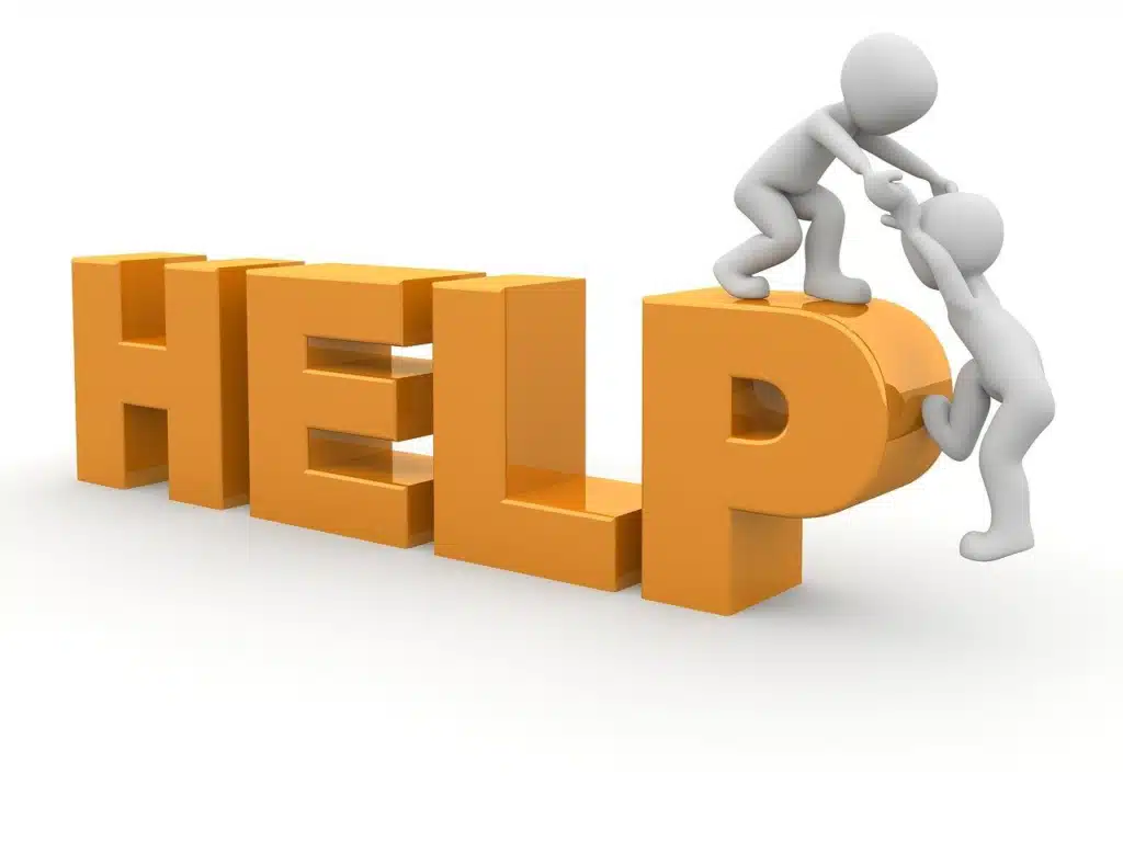 3D illustration of the word 'HELP' in large orange letters, with one white stick figure reaching down to help another stick figure climb up onto the letter 'P', symbolizing targeted support or minimum prompting.
