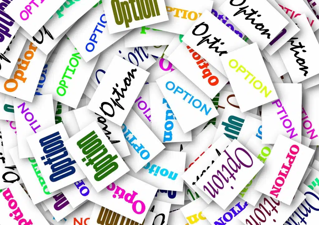 A cluttered pile of white paper slips, each with the word "OPTION" printed on it in various colors and fonts.