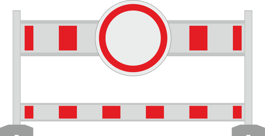 A red and white striped barrier with a red circle in the center, symbolizing a stopping point.